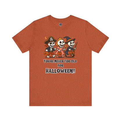 Never Too Old for Halloween T-Shirt – Funny Adult Halloween Shirt in heather autumn, flat laid to emphasize the cozy seasonal palette and skeleton design.