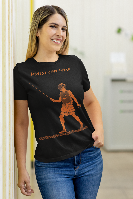 A woman with dyed blond hair wearing a Finesse Over Force T-Shirt – Unisex Fencing Tee for Foil Fencers  from  WhimSpin leans against a wall. The shirt features Greek god Apollo standing in en garde, holding a foil, and wearing a fecing mask while dressed in a short grecian tunic and a breast plate with a lyre depicted on it. - https://whimspin.com