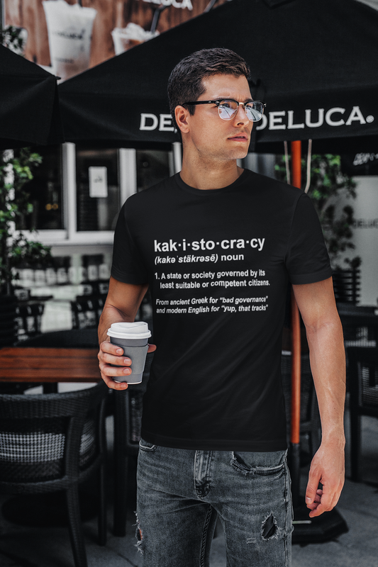 Kakistocracy Definition T-Shirt – Funny Political Protest Graphic Tee shown on a man in black, featuring a satirical definition-style kakistocracy t shirt design.