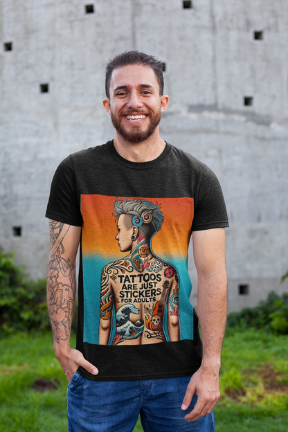 A man with tattoos on his arm wearing a black Tattoos Are Just Stickers For Adults graphic tee from WhimSpin stands outside on grass