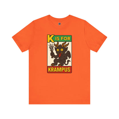 K is for Krampus Alphabet Holiday Graphic T-Shirt in Orange flat lay featuring K is for Krampus retro Christmas graphic