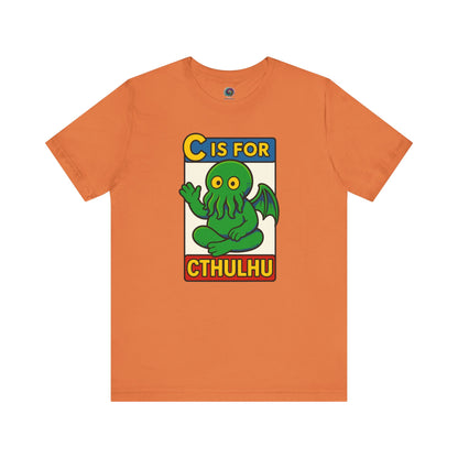 C is for Cthulhu T-Shirt – Lovecraftian Funny Cartoon Tee in burnt orange, flat lay featuring cartoon Cthulhu monster alphabet design.