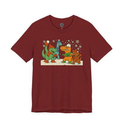 the Dinosaur Snowball Fight T-Shirt – Funny Winter Dino Graphic Tee in Cardinal, featuring bundled dinosaurs throwing snowballs in a lively scene.
