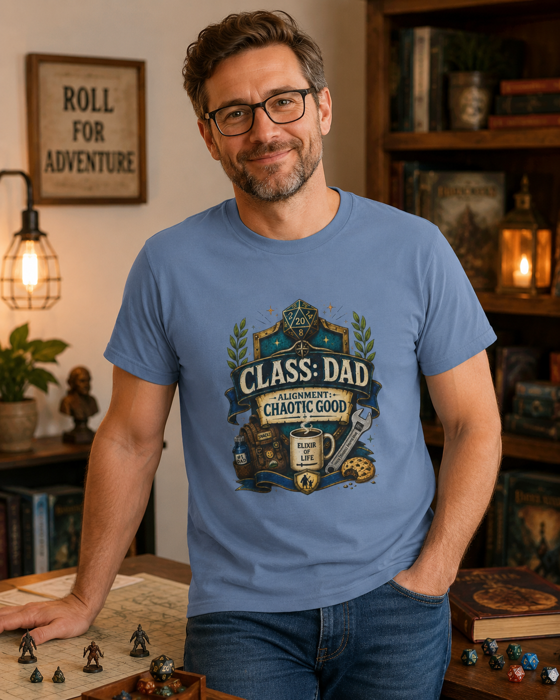 Man wearing a blue t-shirt with a 'Class Dad, Alignment: Chaotic Good' design in a cozy room with books and decor. Great gift for RPG and D&D fans who are dads