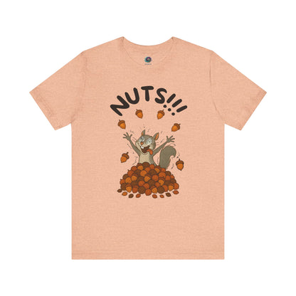 Crazy Squirrel Shirt – Funny Squirrel Nuts T-Shirt for Quirky Style laid flat in heather peach with fun squirrel character and scattered nuts