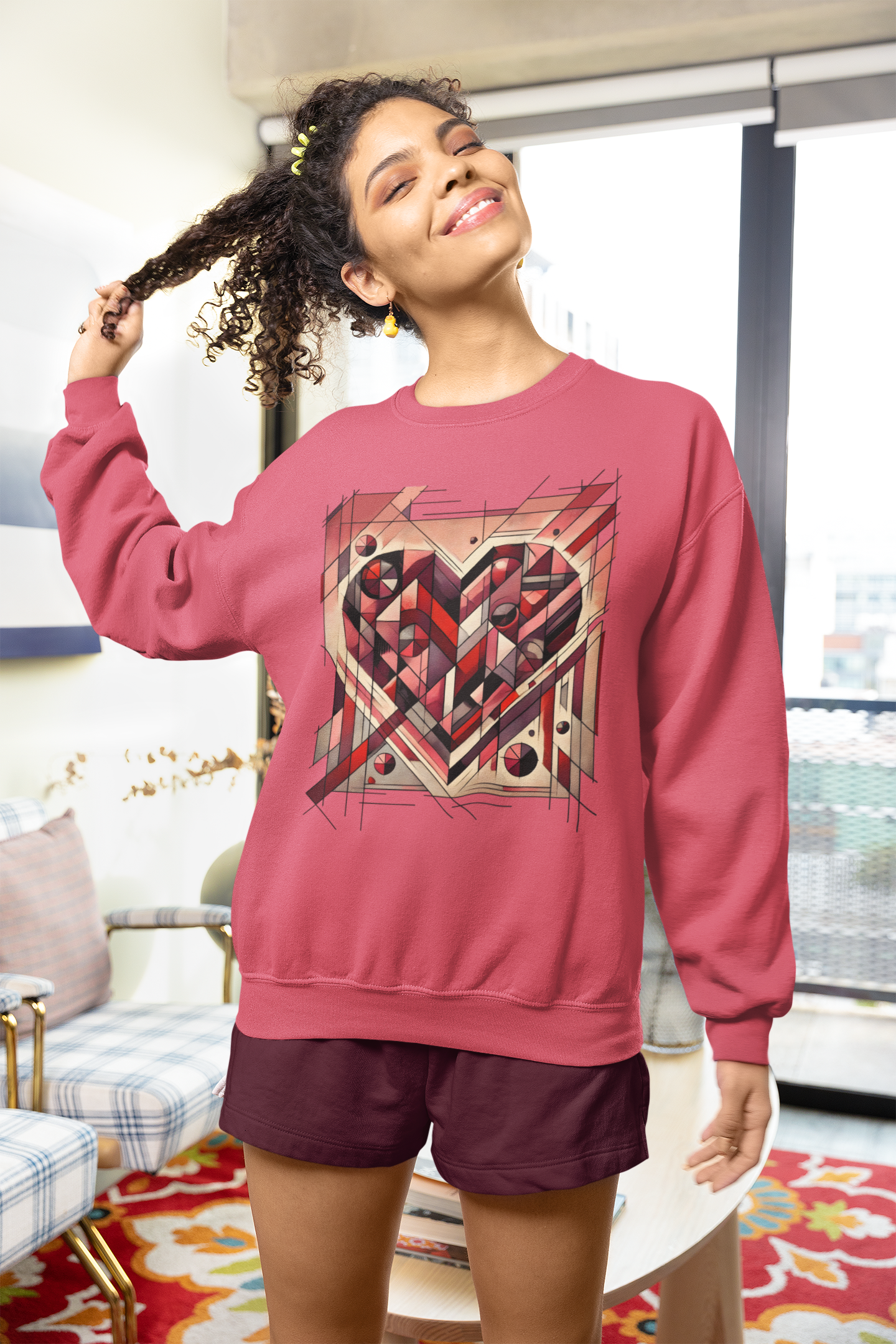Cubist Heart Sweatshirt – Modern Art Valentine’s Day Pullover styled playfully indoors, showing a vibrant pink sweatshirt with abstract heart artwork