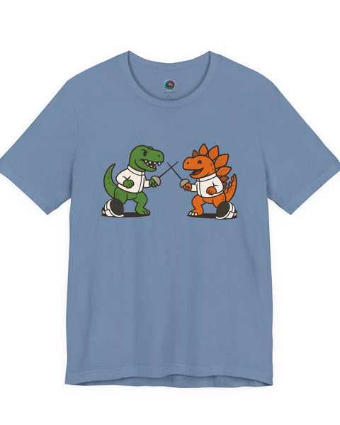 A light blue crewneck t-shirt featuring a graphic of a green dinosaur and an orange dinosaur in white sports jerseys playing a game of rock-paper-scissors.