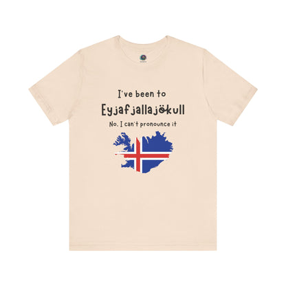 Eyjafjallajökull T-Shirt – Funny Iceland Volcano Travel Merch in soft cream tone, showing the Iceland silhouette and flag beneath Iceland’s famously unpronounceable volcano name.