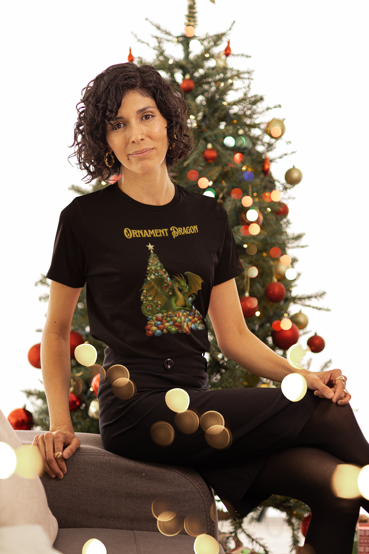 Ornament Dragon T-Shirt – Christmas Dragon Tee for Ornament Lovers, modeled in black shirt with holiday tree background and soft lights
