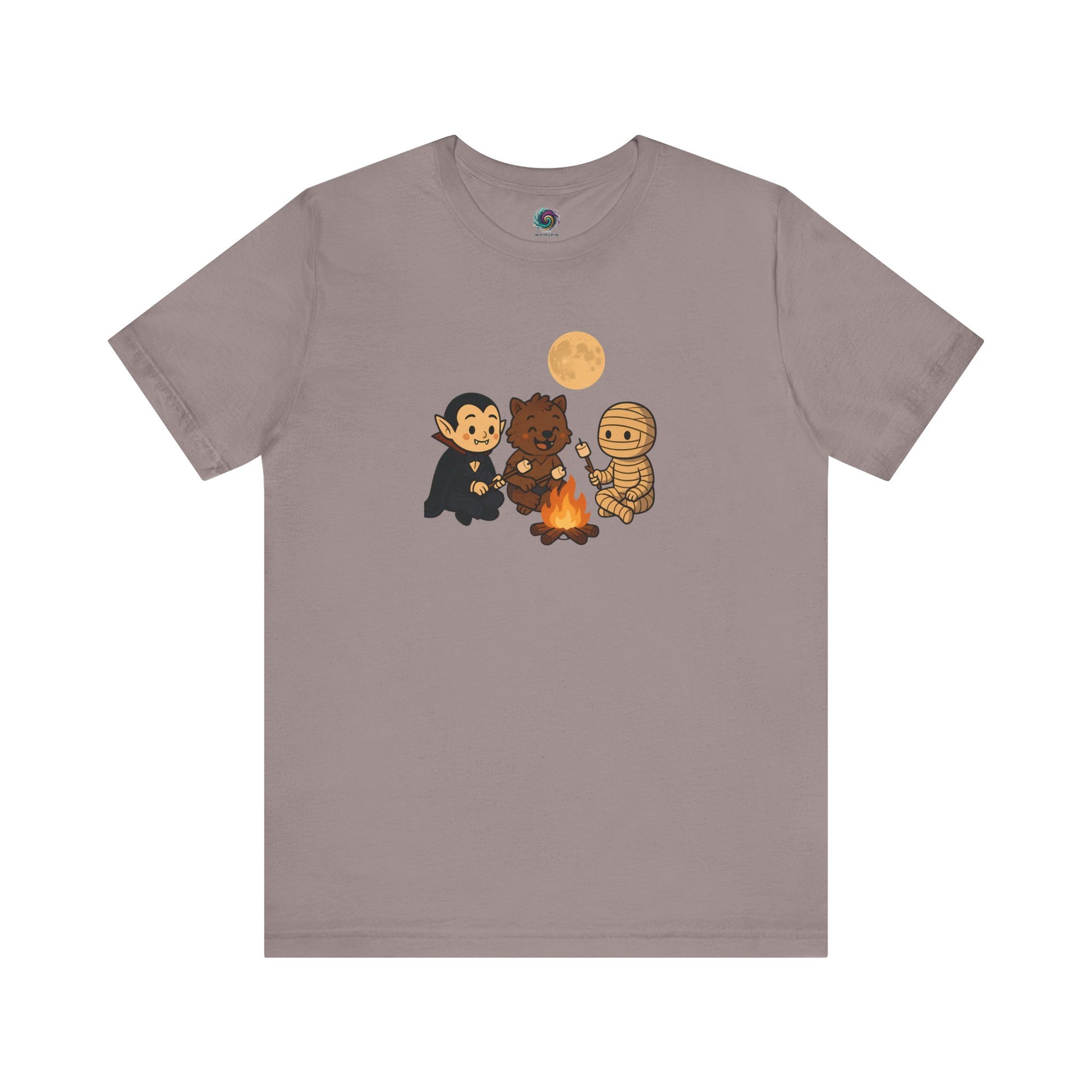 Halloween Monsters Campfire T-Shirt in Pebble Brown from WhimSpin showing a trio of adorable monsters—vampire, werewolf, and mummy—roasting marshmallows under a full moon.