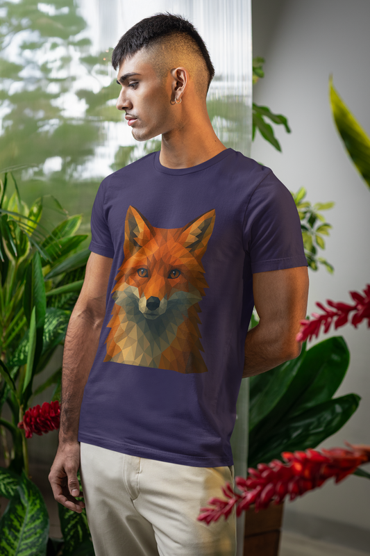 A man wearing a purplish/blue t-shirt with a geometric fox graphic in a room filled  with plants.