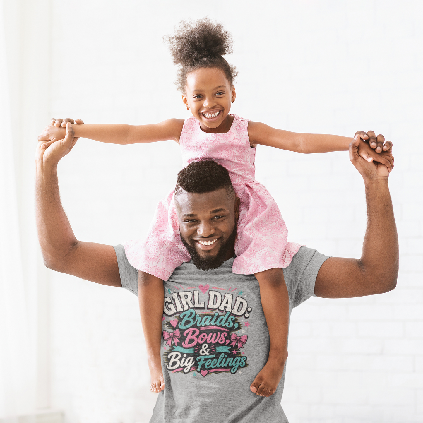 Man with a child on his shoulders wearing a shirt with text and graphics.