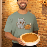 Thanksgiving Cat T-Shirt – Cute Hungry Cat and Turkey Tee shown on man in green shirt smiling with pumpkin pie in rustic fall setting