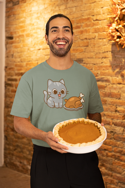 Thanksgiving Cat T-Shirt – Cute Hungry Cat and Turkey Tee shown on man in green shirt smiling with pumpkin pie in rustic fall setting