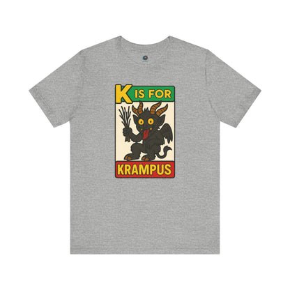 K is for Krampus Alphabet Holiday Graphic T-Shirt in Athletic Heather flat lay with cartoon Krampus and colorful lettering