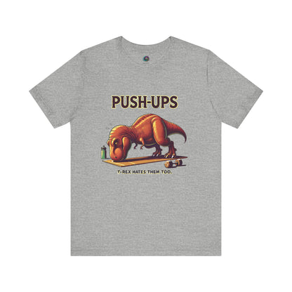 T-Rex Push-Up T-Shirt – Funny Dinosaur Workout Graphic Tee in athletic heather gray, designed for t rex hates push ups lovers and gym rats alike.