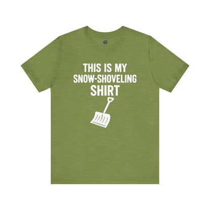 This Is My Snow Shoveling Shirt – Funny Winter Chore Tee in Heather Green, highlighting the bold winter chore message and shovel illustration.