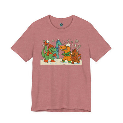 the Dinosaur Snowball Fight T-Shirt – Funny Winter Dino Graphic Tee in Heather Mauve, featuring a soft background for the winter dinosaur scene.