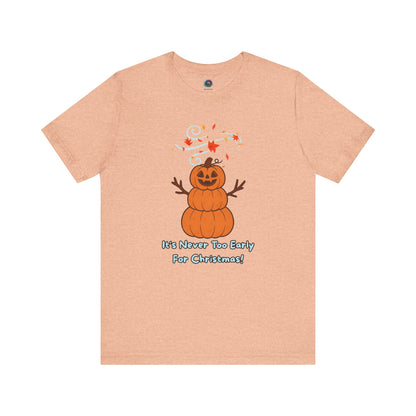 Pumpkin Snowman T-Shirt – It’s Never Too Early for Christmas in heather peach, cheerful seasonal mashup with pumpkin snowman.