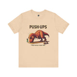 T-Rex Push-Up T-Shirt – Funny Dinosaur Workout Graphic Tee in heather sand dune, showcasing a goofy t rex push up design great for fitness motivation with workourt t rex.
