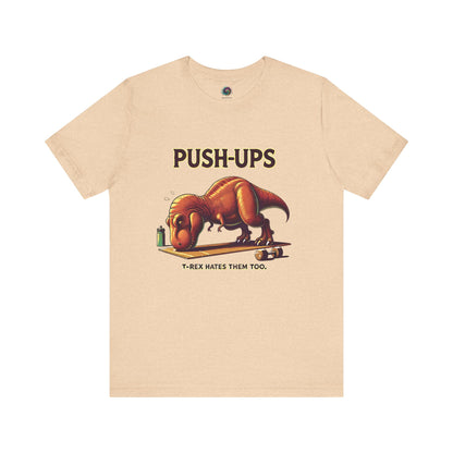 T-Rex Push-Up T-Shirt – Funny Dinosaur Workout Graphic Tee in heather sand dune, showcasing a goofy t rex push up design great for fitness motivation with workourt t rex.