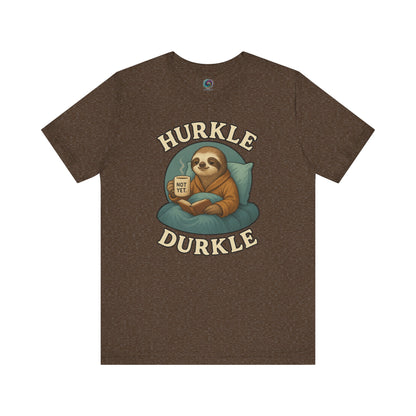 Hurkle Durkle Sloth T-Shirt – Cozy Sloth Shirt for Lazy Days shown flat in Heather Brown with relaxed sloth reading a book and sipping coffee