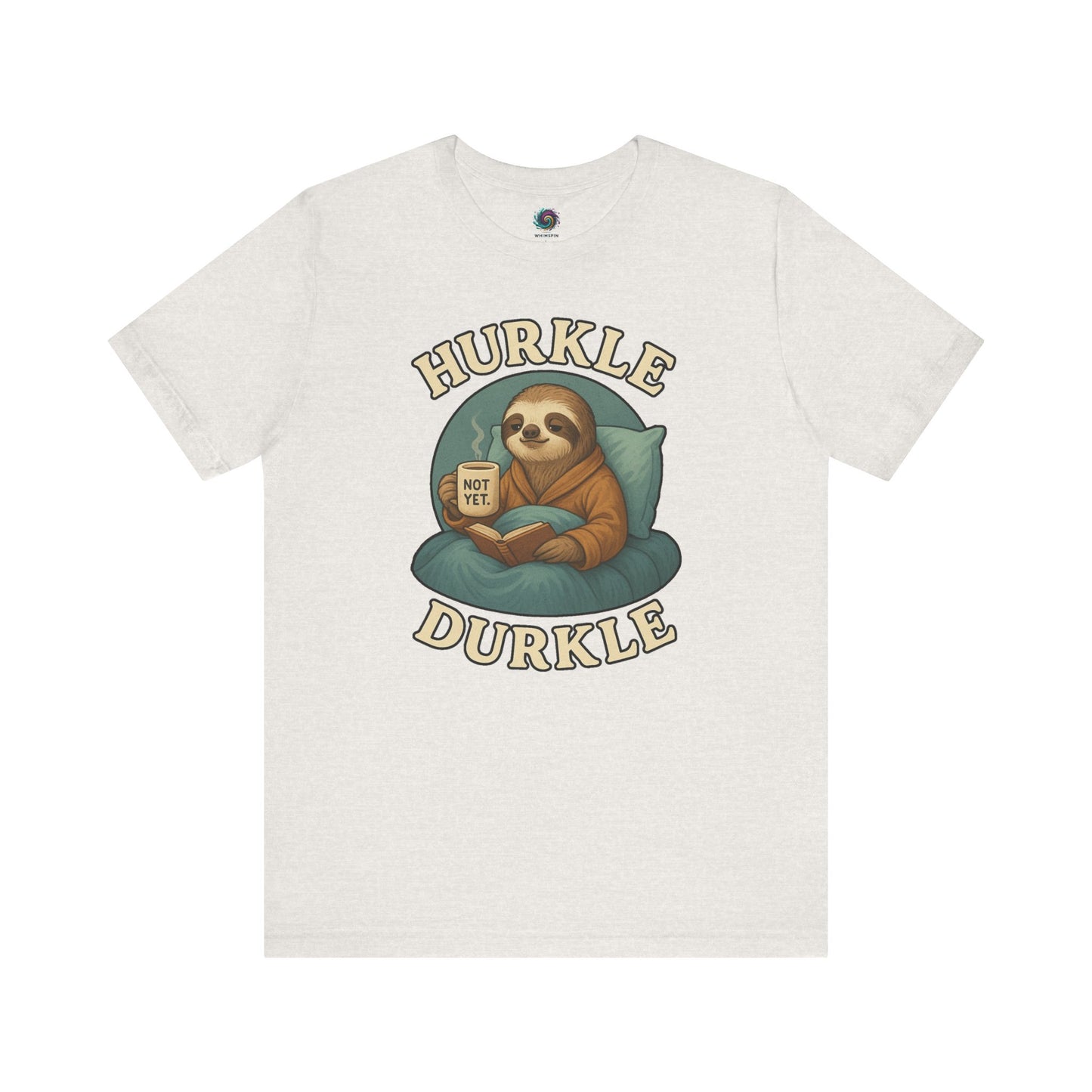 Hurkle Durkle Sloth T-Shirt – Cozy Sloth Shirt for Lazy Days laid flat in Heather Cement featuring a sloth, book, and warm beverage