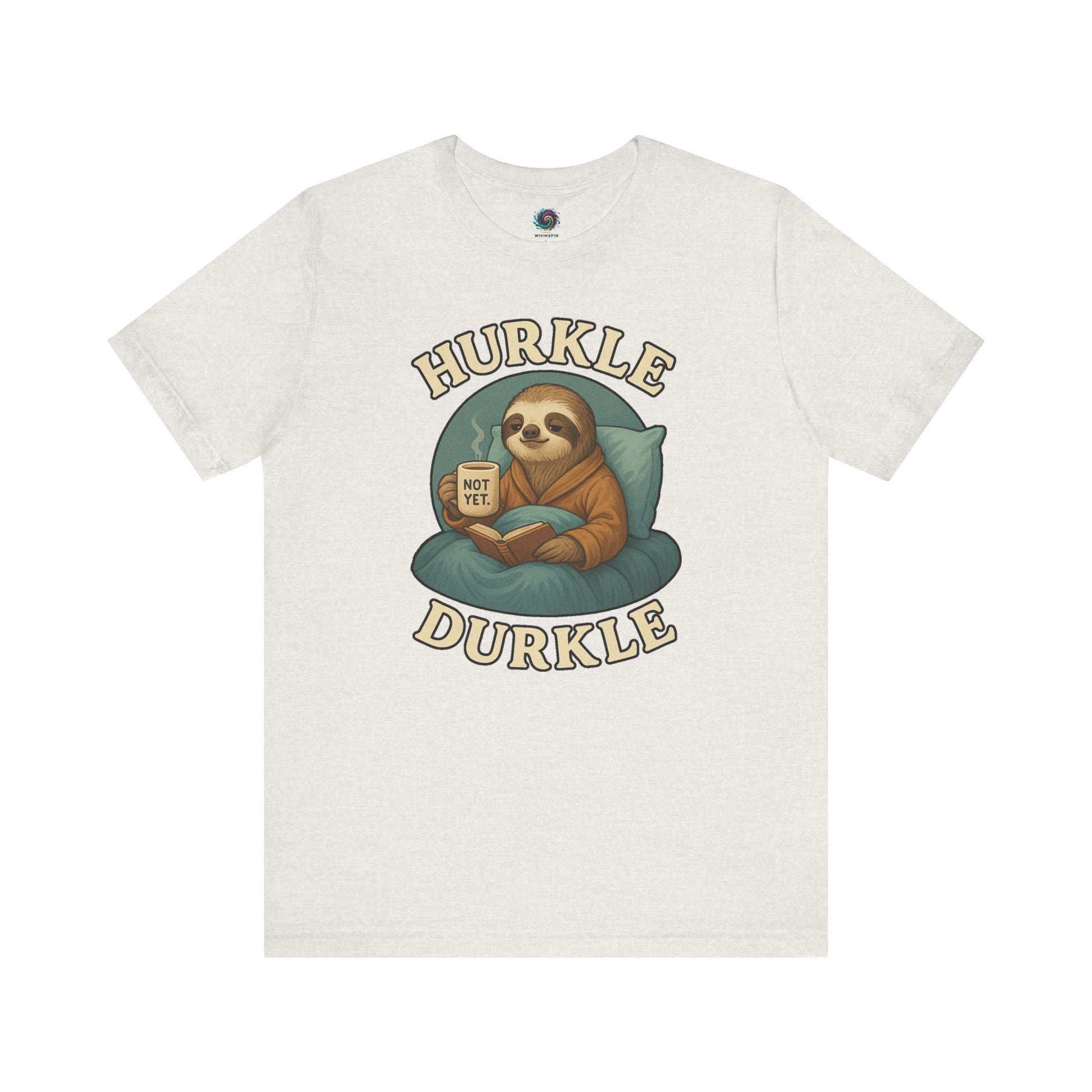 Hurkle Durkle Sloth T-Shirt – Cozy Sloth Shirt for Lazy Days laid flat in Heather Cement featuring a sloth, book, and warm beverage