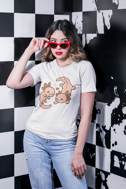 A woman wearing the Kawaii Axolotl T-Shirt from WhimSpin  in white sliding sunglasses down her nose,. The t-shirt image is of a pair of Kawaii style axoltols swimming around each other and forming a Ying Yang withe their bodies.