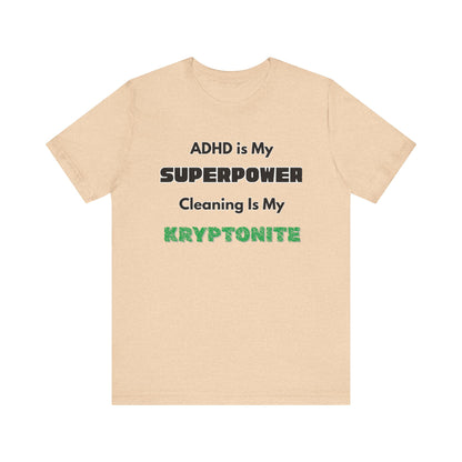 ADHD Cleaning Kryptonite T-Shirt – Funny Shirt for Neurodivergent Humor in heather sand dune with green kryptonite lettering