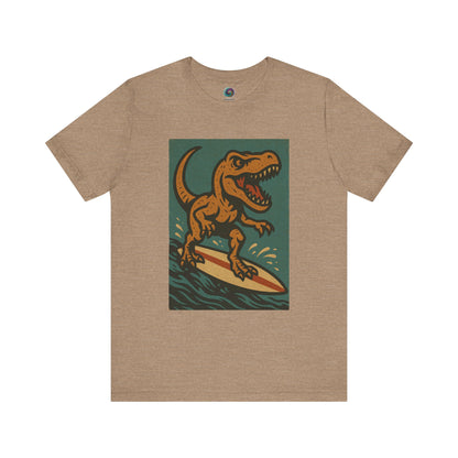 Surfing T-Rex T-Shirt – Funny surfing Dinosaur Graphic Tee  in heather tan, featuring a dinosaur surf scene — a chill pick for your next beach trip.