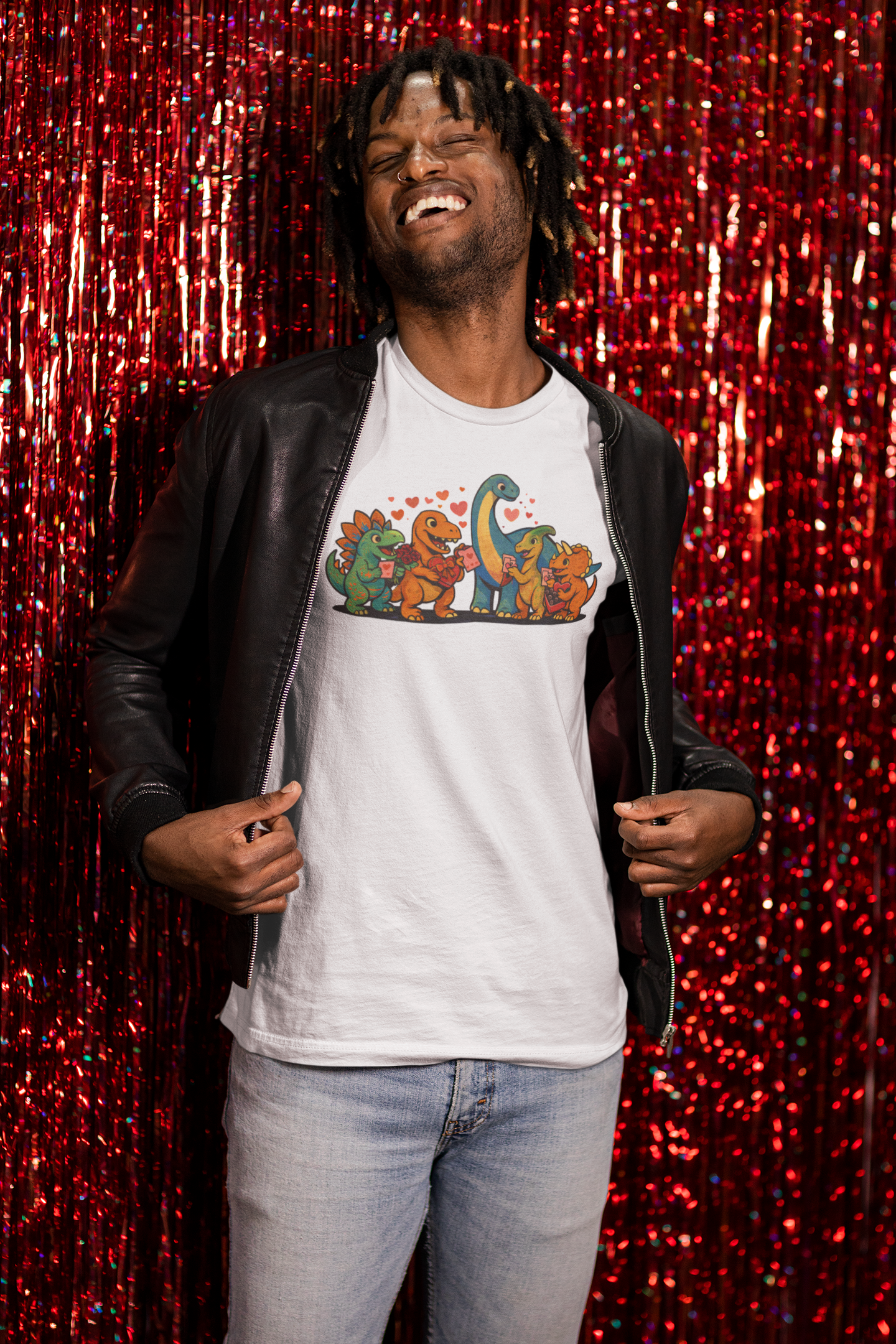 Dinosaur Valentines T-Shirt – Cute Dino Valentine’s Day Tee shown on a smiling model against a shimmering red backdrop, highlighting playful dinosaur valentines artwork filled with hearts