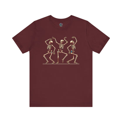 Maroon shirt featuring trio of animated skeletons dancing across the front—perfect for fall festivities and Halloween parties.