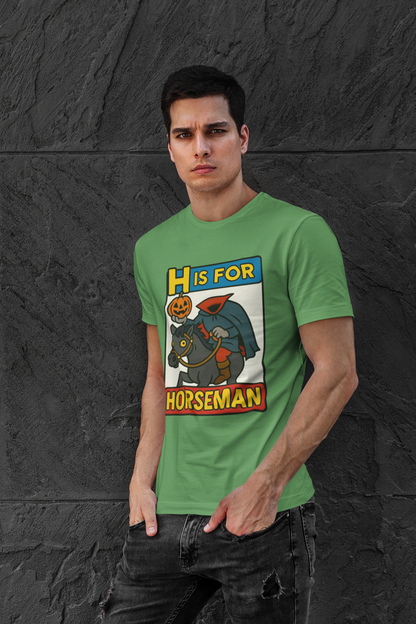 H is for Horseman T-Shirt – Headless Horseman Halloween Tee in leaf green, lifestyle photo with bold cartoon pumpkin-headed rider, funny Halloween horseman shirt.