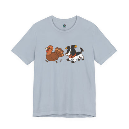 Dog Chasing Turkey T-Shirt – Funny Thanksgiving Dog Tee in light blue with festive chase scene graphic