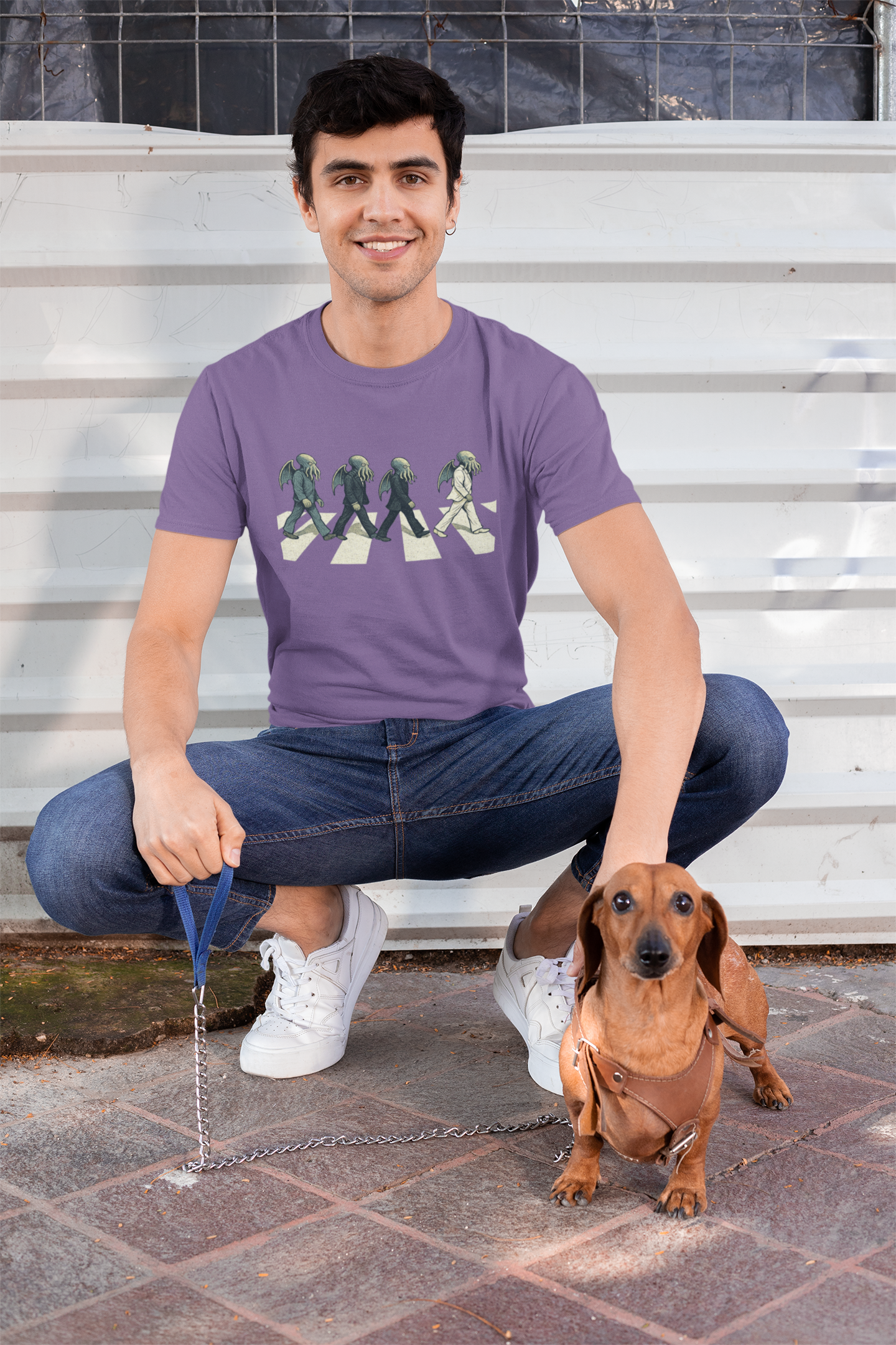 Cthulhu Crossing T-Shirt – Beatles Abbey Road Parody Tee in light purple, lifestyle shot with dachshund, Abbey Road parody t shirt with cute Cthulhu.