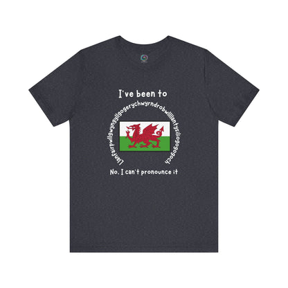 Llanfairpwllgwyngyllgogerychwyrndrobwllllantysiliogogogoch T-Shirt – Funny Wales Travel Merch in heather navy blue with long place name and red dragon flag artwork.