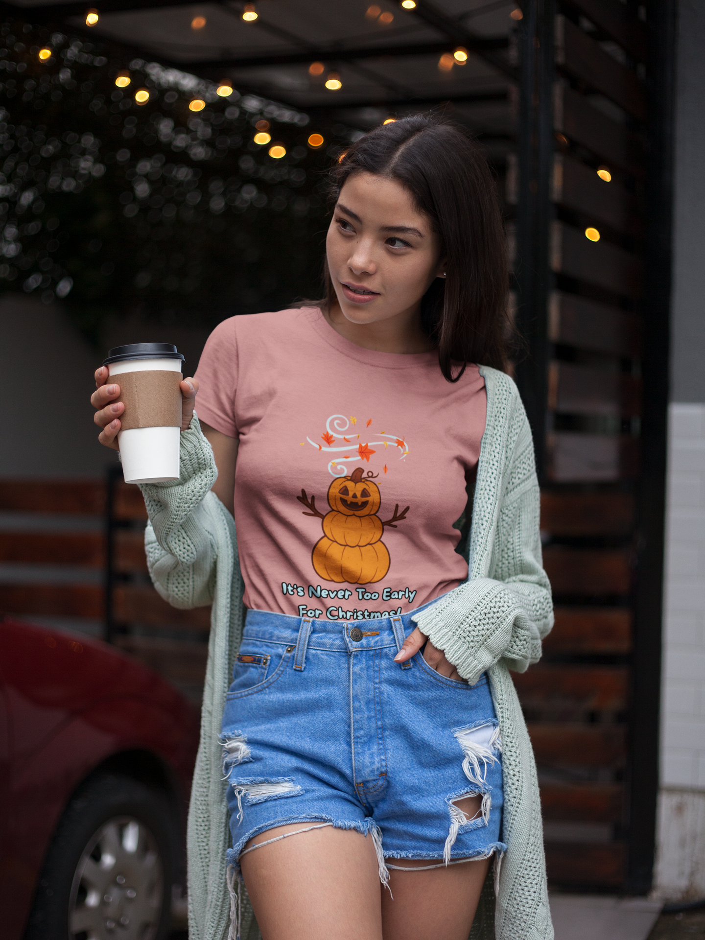 Pumpkin Snowman T-Shirt – It’s Never Too Early for Christmas printed on mauve, lifestyle photo featuring pumpkin snowman design as a seasonal Halloween Christmas shirt.
