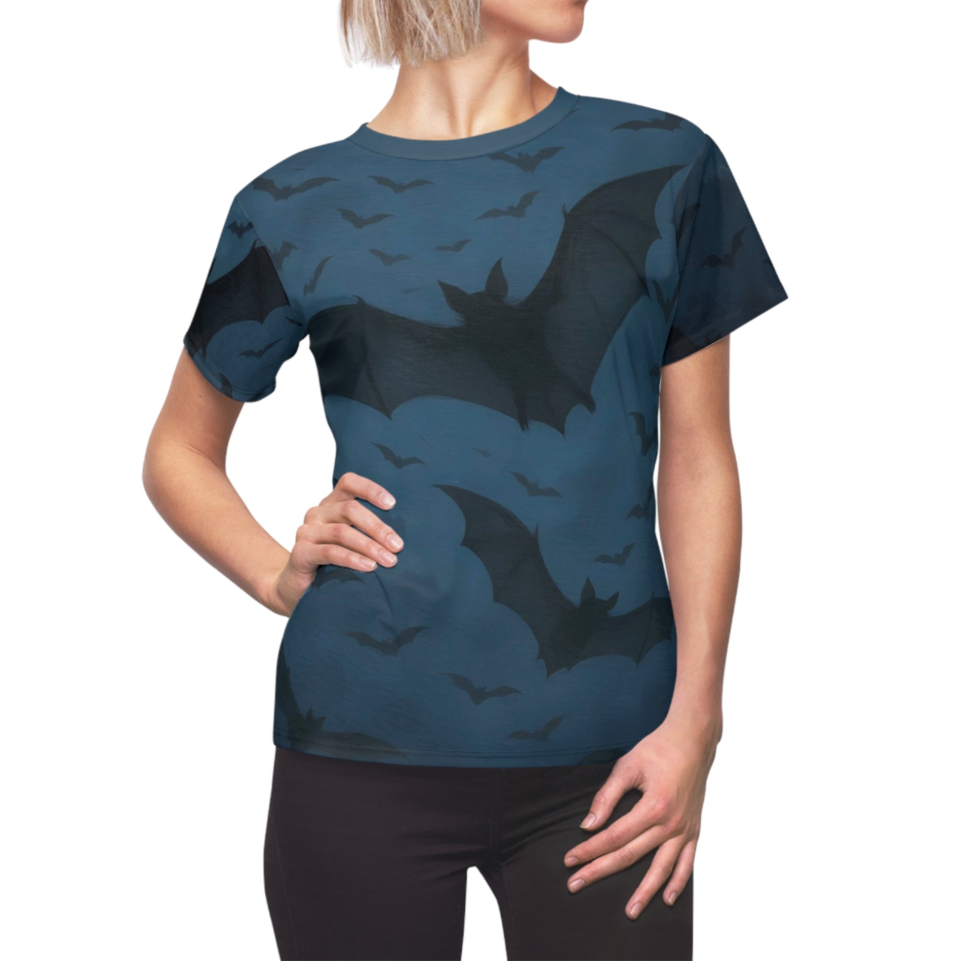 Side view of a woman modeling the Bats in the Sky Women’s AOP Shirt – Night Sky Bat All-Over Print, with scattered bats in a twilight sky covering the shirt.