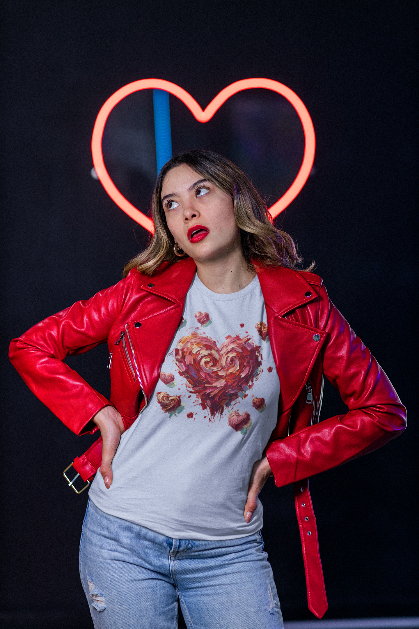 Woman in red jacket stands in front of neon heart wearing White Impressionistic Heart T-Shirt – Artistic Valentine's Day Tee