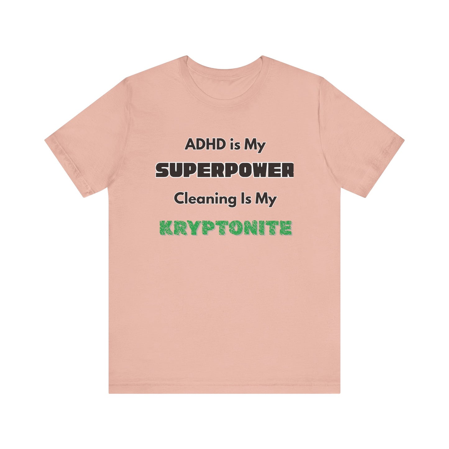 ADHD Cleaning Kryptonite T-Shirt – Funny Shirt for Neurodivergent Humor in peach with bold text emphasizing ADHD and kryptonite