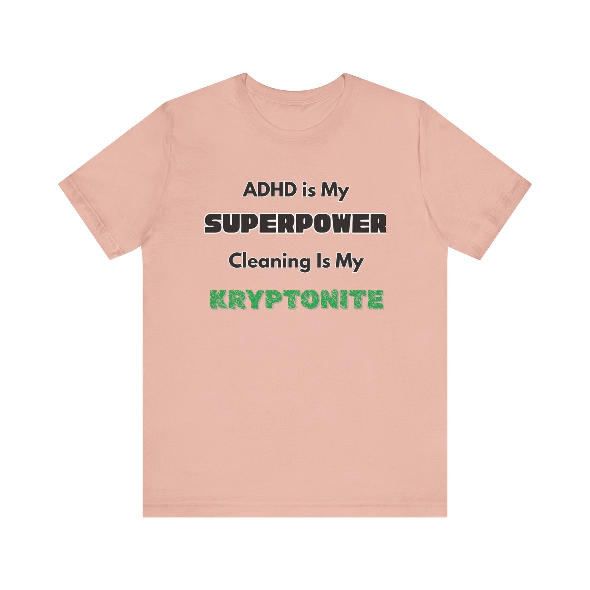 ADHD Cleaning Kryptonite T-Shirt – Funny Shirt for Neurodivergent Humor in peach with bold text emphasizing ADHD and kryptonite
