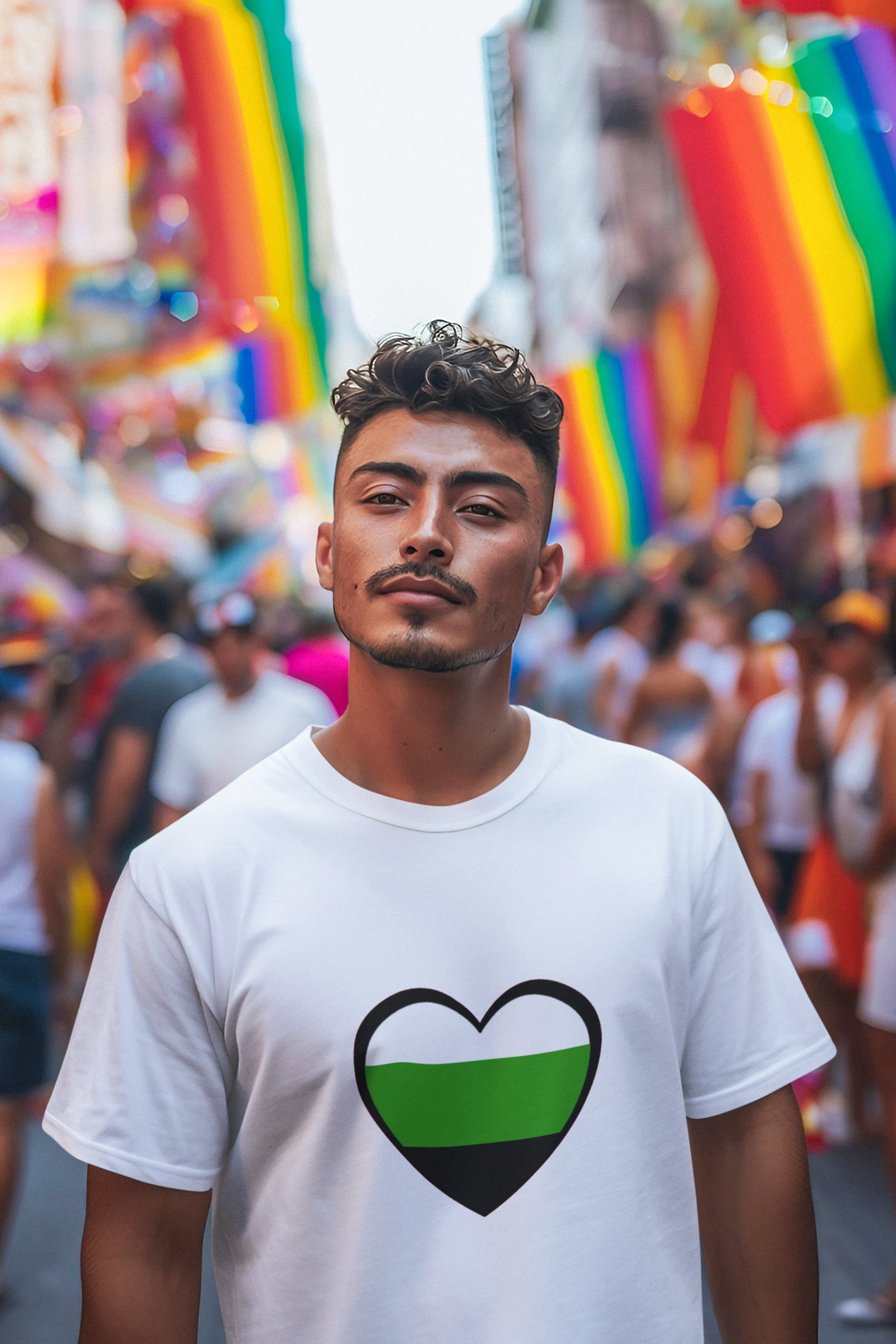 Man in white Aromantic Heart Pride T-Shirt with bold neutrois heart symbol stands confidently at a bustling pride event filled with colorful LGBTQ+ flags. Shirt represents neutrois pride and minimalist gender identity expression.