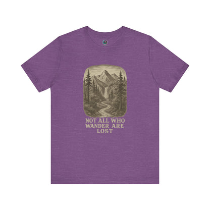 Heather team purple “Not All Who Wander Are Lost T-Shirt – Tolkien Travel Tee for Nature Lovers” with sketched pine trees and mountain art