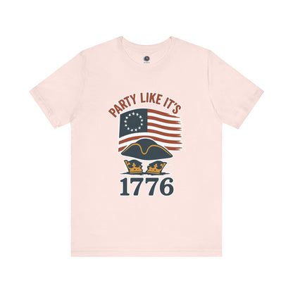 Pink t-shirt with text that says 'Party Like It's 1776'  and an American flag and tricorner hat graphic design 