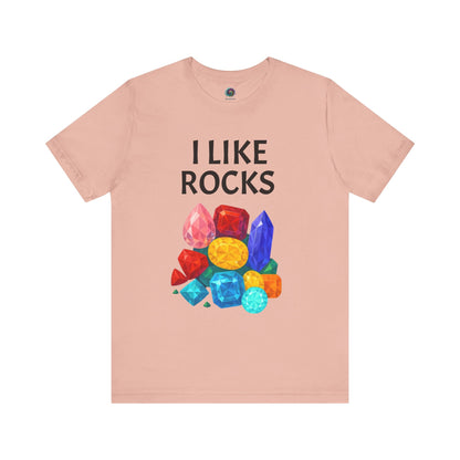 Peach  t-shirt with 'I Like Rocks' text and colorful gemstone graphics on a white background