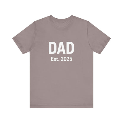 Dad Est. 2025 T-Shirt – New Dad Shirt, First Father’s Day Gift, Pregnancy Announcement Tee in pebble brown flat lay with rustic tones