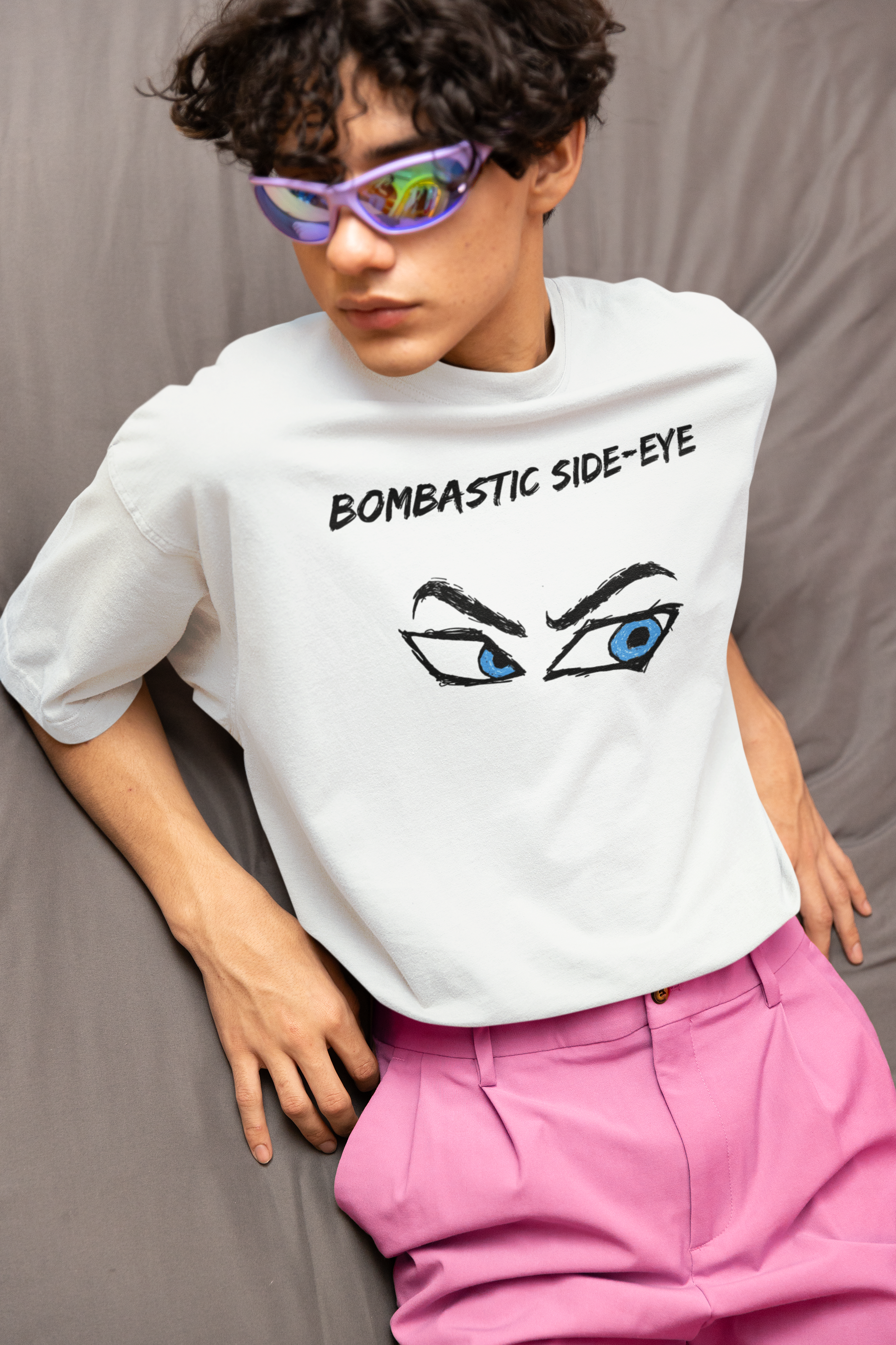 A person wearing the Bombastic Side-Eye T-Shirt – Comic Book Style Meme Graphic Tee in white, paired with bright pink pants and showing the expressive comic eye graphic.