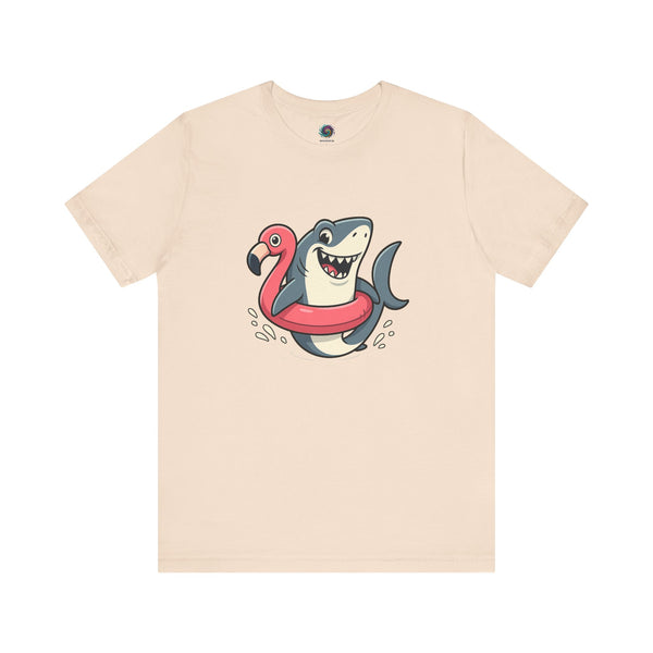 Shark Flamingo Floatie T-Shirt – Funny Beach & Pool Day Tee in soft cream with lighthearted cartoon of shark in floatie