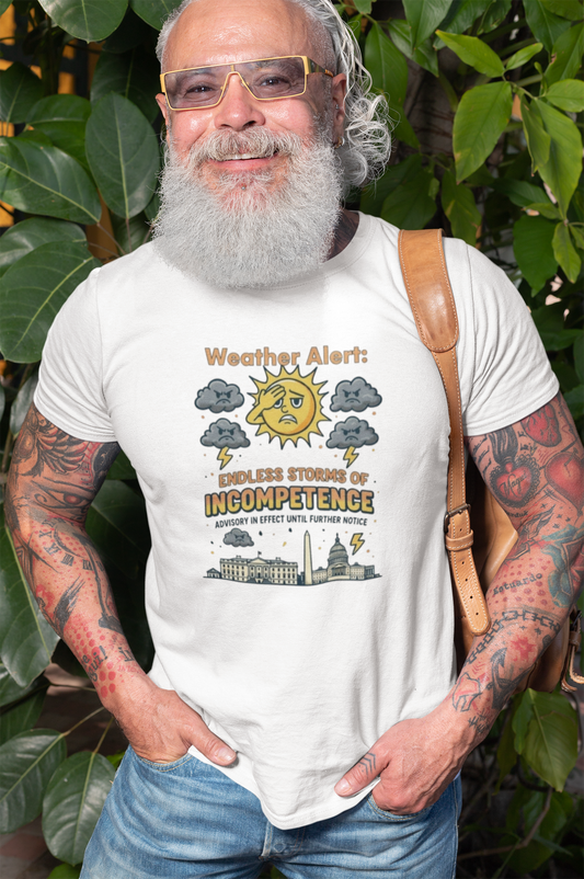 A bearded man with tattoos smiles while wearing the Weather Alert: Endless Storms of Incompetence Political Satire T-Shirt in white. Funny weather-themed government protest shirt with storm clouds and Capitol.